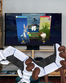 A meme made by the official Looney Tunes Twitter account depicting Bugs and Taz playing MultiVersus on a PS5.